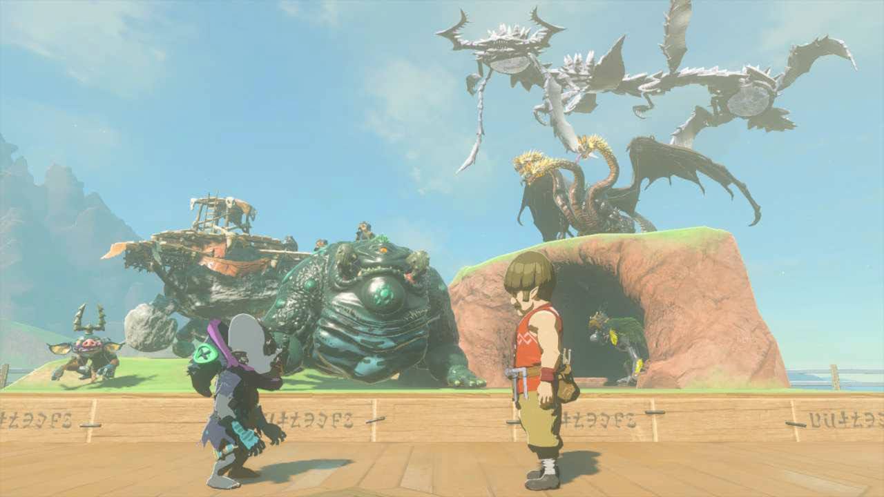 Two people standing in front of a slightly raised diorama outdoors in daylight. There are six monsters in the diorama: a Bokoblin, Horriblin, Battle Talus, Frox, Thunder Gleeok and Colgera.