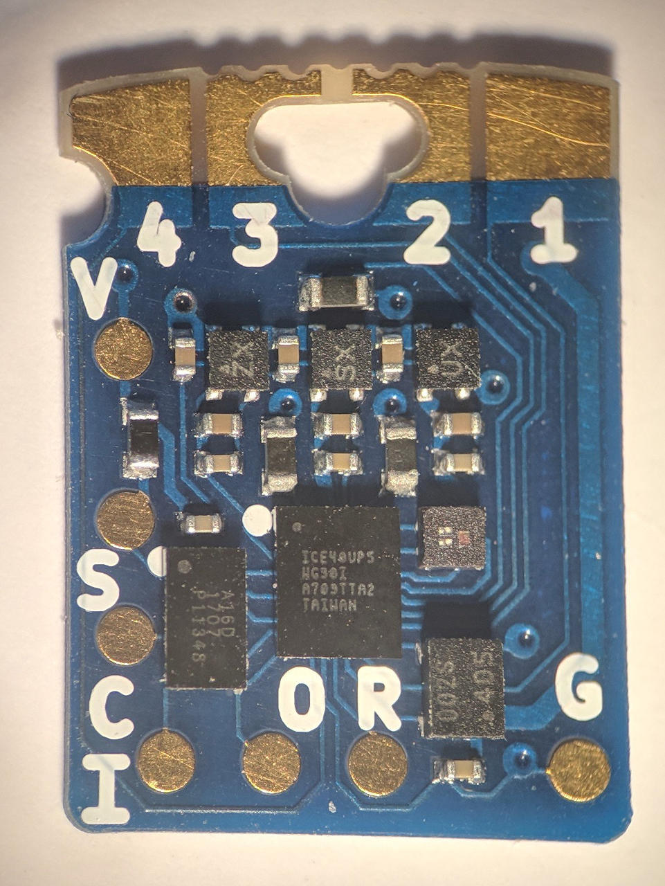 A photo of the board component side. There are seven integrated circuits and bare copper pads labelled clockwise from the top left 4, 3, 2, 1, G, R, O, I, C, S and V.